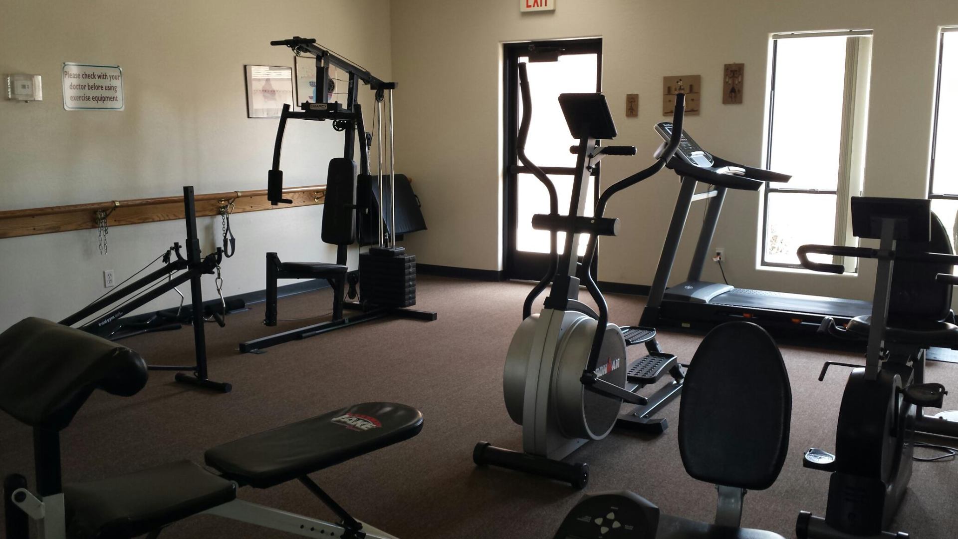 On-site fitness room with cardio and strength equipment